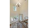 Grand two-story foyer with chandelier, large windows, and staircase at 108 Berry Mill Ln # 132, Raleigh, NC 27603