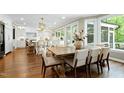 Open dining area with hardwood floors, modern lighting, and backyard views at 111 Finnway Ln, Cary, NC 27519