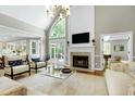 Bright living room with vaulted ceilings, fireplace, and large windows at 111 Finnway Ln, Cary, NC 27519