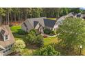 Aerial view of the home showcasing the property, mature trees, and manicured lawn at 1141 Contender Dr, Clayton, NC 27520