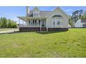 Beautiful home with a classic design, featuring a welcoming porch, and neatly maintained landscaping at 1156 Darius Pearce Rd, Youngsville, NC 27596