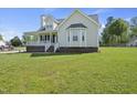 Classic home with bay window, covered porch, and pristine lawn, ideal for gracious living at 1156 Darius Pearce Rd, Youngsville, NC 27596