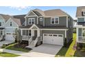 Attractive two-story home with covered front porch, stone accents, and a convenient two-car garage at 1245 Porters Call Dr, Wendell, NC 27591