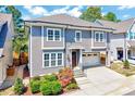 Charming two-story home featuring a manicured front yard, attached garage, and stylish gray siding at 1309 Pecora Ln, Raleigh, NC 27607