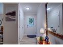Bright foyer features light hardwood floors, neutral walls, and a decorative mirror enhancing the space at 1536 Dirkson Ct, Cary, NC 27511