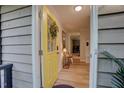 Inviting front door painted yellow with glass panes and a decorative wreath, opening to a light-filled home at 1536 Dirkson Ct, Cary, NC 27511