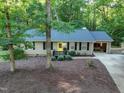 Charming one-story home with a welcoming yellow door, black shutters, and a well-manicured lawn at 1536 Dirkson Ct, Cary, NC 27511