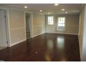 Bright living room boasts gleaming hardwood floors, neutral paint, and natural light at 176 Fletcher Ave, Fuquay Varina, NC 27526
