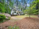 Charming two-story home with a brick walkway, front porch, and blooming flower beds at 2001 Virginia Dare Pl, Raleigh, NC 27610