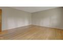 Bright bedroom featuring hardwood floors, neutral walls, and ample natural light at 208 Clark Lake Rd, Durham, NC 27707