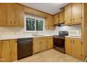 Updated kitchen with stainless steel appliances, white subway tile backsplash, and wood cabinets at 208 Clark Lake Rd, Durham, NC 27707