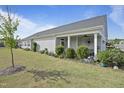 Exterior view of this home with a covered porch, manicured lawn, and tasteful landscaping at 21 Davidson St, Clayton, NC 27527