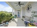 Inviting front porch with blue ceiling, bench seating, potted plants, and decorative compass at 21 Davidson St, Clayton, NC 27527