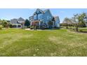 Expansive front yard of a charming two-story home with beautifully maintained landscaping and mature trees at 2113 Rockwall Farms Ln, Fuquay Varina, NC 27526