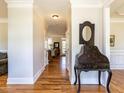 Elegant hallway with hardwood floors, white trim, and decorative table, leading into the living space at 2113 Rockwall Farms Ln, Fuquay Varina, NC 27526