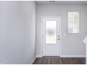 Bright entryway featuring a frosted glass door, light grey walls, and a window for natural light at 2126 Willow Gln Dr, Graham, NC 27253