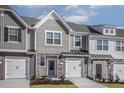 Charming townhouse with a mix of stone, brick, and shingle exterior, complemented by a white garage door at 2126 Willow Gln Dr, Graham, NC 27253