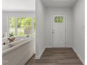 Bright entryway featuring hardwood floors and a clear view into the cozy living room at 216 Burkwood Ln, Raleigh, NC 27609