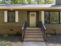 Inviting entrance with brick stairs, dark railings and olive green siding at 216 Burkwood Ln, Raleigh, NC 27609