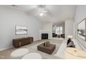 Bright living room featuring a fireplace, neutral tones, elegant furnishings, and seamless flow into the adjacent room at 2411 Vancastle Way # 202, Raleigh, NC 27617