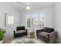 Charming sitting room with two plush chairs, a decorative mirror, ample natural light, and a cozy atmosphere at 2411 Vancastle Way # 202, Raleigh, NC 27617