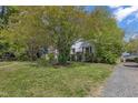 Quaint home with a well-maintained lawn and mature trees providing shade at 2522 N Roxboro St, Durham, NC 27704
