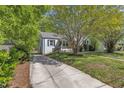 Inviting home with a concrete driveway and mature trees in the front yard at 2522 N Roxboro St, Durham, NC 27704