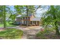 Landscaped brick home on a large lot with mature trees at 254 Pine Forest Dr, Siler City, NC 27344