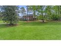 Traditional brick home with black shutters set on a large manicured lawn at 254 Pine Forest Dr, Siler City, NC 27344