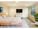 Modern bedroom with stylish furniture, TV, and bright neutral decor and natural light at 32 Bellini Dr, Angier, NC 27501