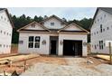 New construction featuring a charming one-story home with an attached garage and gravel driveway at 330 Bluejay St, Clayton, NC 27520