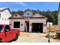New construction home featuring modern design with a two-car garage in a developing neighborhood at 330 Bluejay St, Clayton, NC 27520