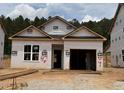 New construction featuring a single-story home with a garage, framed windows, and a roof, in a wooded area at 330 Bluejay St, Clayton, NC 27520