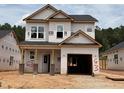 Two-story home featuring an unfinished exterior, a front entrance, and an attached garage at 338 Bluejay St, Clayton, NC 27520
