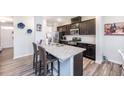 Open concept kitchen featuring granite countertops, a kitchen island with seating, and stainless appliances at 35 October Glory Way, Franklinton, NC 27525