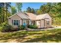 A single-story home with a welcoming porch and a well-manicured lawn at 4290 Sustain Cir, Franklinton, NC 27525