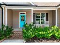 Inviting front porch with rocking chairs and a turquoise front door at 4290 Sustain Cir, Franklinton, NC 27525