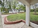 Spacious backyard featuring well-maintained lawn, brick accents, and white brick exterior at 508 & 510 Gordon St, Roxboro, NC 27573
