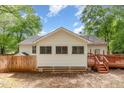 Back of home features wooden deck, fenced yard and windows at 508 Baygall Rd, Holly Springs, NC 27540