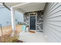 Inviting front porch featuring a stylish door, stone accents, and a cozy seating area at 512 Oak Holly Ln, Zebulon, NC 27597