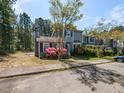 Inviting exterior of a well maintained townhouse showcasing mature landscaping and a lush surrounding environment at 519 Touchstone Dr, Durham, NC 27713