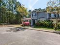 Inviting home featuring a well-maintained lawn with beautiful flowering bushes and mature shade trees at 519 Touchstone Dr, Durham, NC 27713