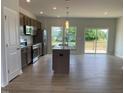 Bright kitchen features an island, stainless steel appliances, and wood cabinets at 54 Grove Township Way, Angier, NC 27501