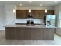 Modern kitchen boasts an island with granite countertops, stainless appliances, and a tile backsplash at 54 Grove Township Way, Angier, NC 27501