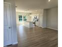 Open-concept kitchen and living area with modern white cabinets and stainless steel appliances at 54 Grove Township Way, Angier, NC 27501