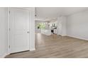 Bright, open-concept living room with modern flooring and neutral paint, flowing into the kitchen at 54 Grove Township Way, Angier, NC 27501