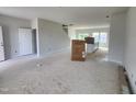 Bright living room with an open floor plan, leading to a modern kitchen area at 54 Grove Township Way, Angier, NC 27501