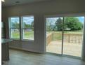 View of the outdoor patio through sliding glass doors and windows at 54 Grove Township Way, Angier, NC 27501