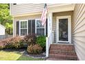 Welcoming front porch with brick steps and a storm door entrance at 5413 Botany Bay Dr, Raleigh, NC 27616