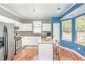 Modern kitchen with white cabinets, granite countertops, stainless steel appliances, and a kitchen island at 5413 Botany Bay Dr, Raleigh, NC 27616